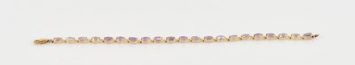 Lot 1249 - A 9ct yellow gold bracelet, set with...