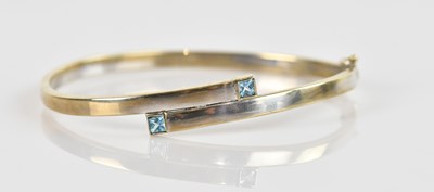 Lot 1238 - A 9ct white gold hinged snap bangle, set with...