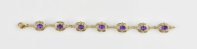 Lot 1239 - A yellow metal openwork amethyst set bracelet,...