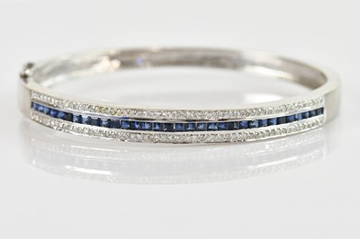 Lot 1143 - A 9ct white gold diamond and sapphire hinged...