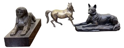 Lot 591 - A modern bronzed resin figure of a recumbent...