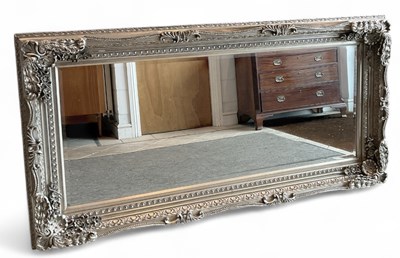 Lot 54 - A large modern silvered elaborately framed...
