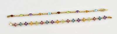 Lot 1315 - A yellow metal multigem set floral bracelet,...