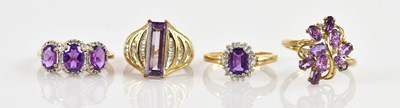 Lot 2523 - Four 9ct yellow gold amethyst set dress rings,...
