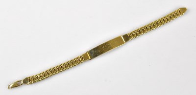 Lot 1127 - A yellow metal flat link identity bracelet,...