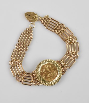 Lot 1112 - A 9ct yellow gold gate link sovereign bracelet,...
