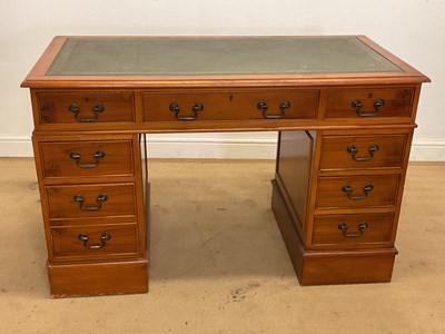 Lot 849 - A reproduction pedestal desk with a green...