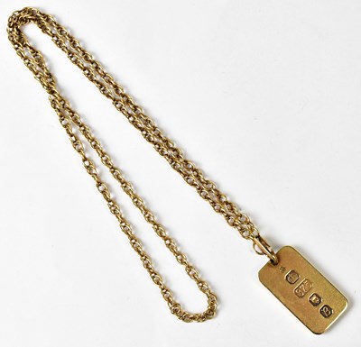 Lot 1254 - A 9ct gold ingot pendant on a 9ct gold double...