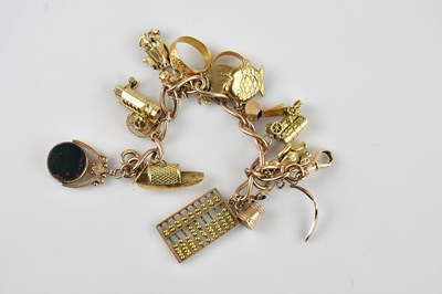 Lot 1106 - A 9ct yellow gold oval link charm bracelet,...