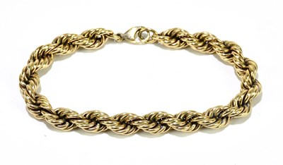 Lot 1065 - A yellow metal rope twist bracelet, stamped...