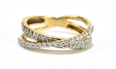 Lot 1150 - A 9ct yellow gold diamond set crossover ring,...