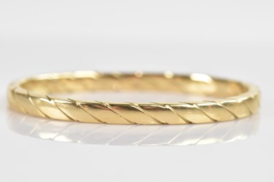 Lot 1206 - A 9ct yellow gold hinged snap bangle with...
