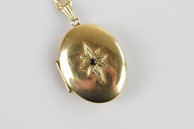 Lot 2128 - A 9ct yellow gold locket of oval form, set...