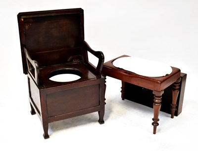 Lot 44 - An oak commode with hinged lid, fold-up arms...