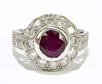 Lot 1049 - A white metal diamond and ruby ring, stamped...