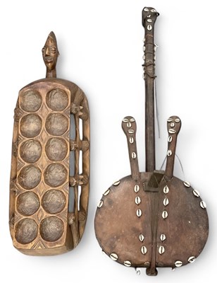 Lot 595 - A West African animal skin and shell beaded...