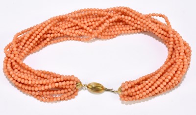 Lot 1334 - A multi strand coral bead necklace with yellow...