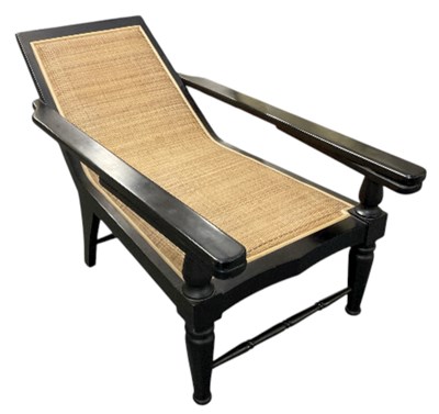 Lot 59 - A modern ebonised rush seated plantation chair,...