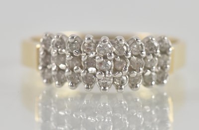 Lot 1305 - A 14k yellow gold diamond cluster ring, the...