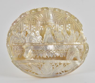 Lot 315 - A mother of pearl carved oval shell depicting...