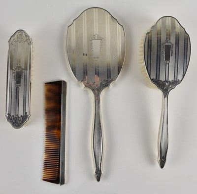 Lot 1249 - A four piece Art Deco sterling silver dressing...