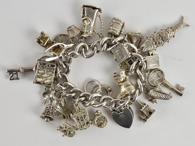 Lot 1469 - A 925 silver charm bracelet, on substantial...