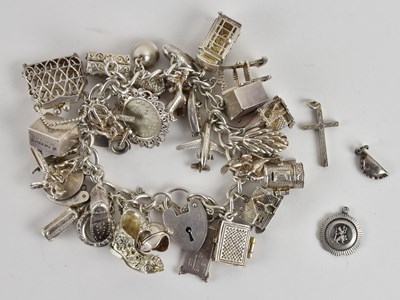Lot 1470 - A 925 silver charm bracelet, with three...