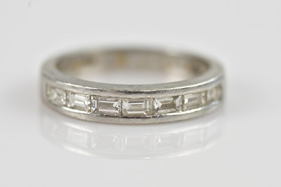 Lot 2392 - A platinum and diamond set band, set with...