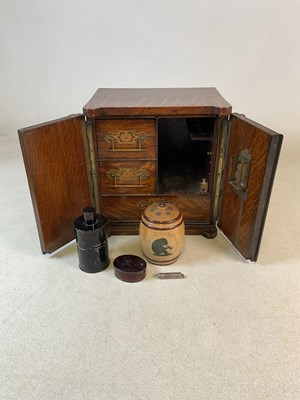 Lot 29 - An unusual Edwardian smoking cabinet, modelled...