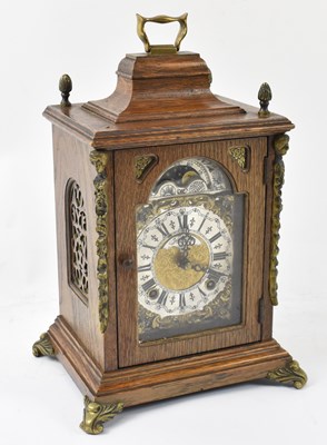 Lot 108 - A 20th century oak cased mantel clock formed...