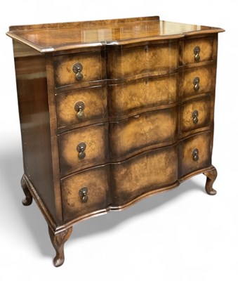 Lot 79 - A 1930s walnut serpentine fronted glass topped...