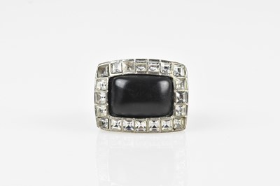 Lot 247 - CHANEL; a silver tone heavy ring, with black...