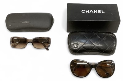 Lot 455 - CHANEL; two cased pairs of lady's sunglasses,...