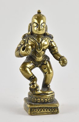 Lot 1085 - A small Indian gilt bronze figure of Krishna,...