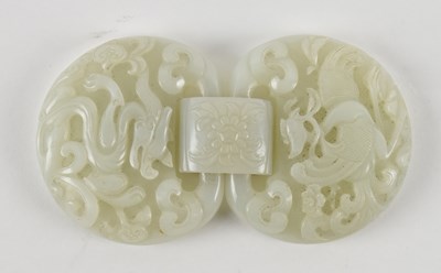 Lot 1015 - A Chinese white jade belt buckle, decorated...