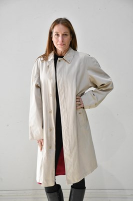 Lot 338 - BURBERRYS; a knee length lady's beige raincoat,...