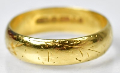 Lot 1130 - An 18ct gold wedding band with engraved...