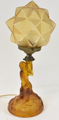 Lot 122 - An Art Deco amber coloured glass figural lamp...