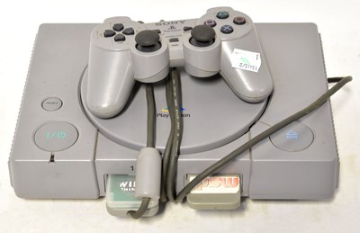 Lot 649 - A Sony Playstation, with one controller.