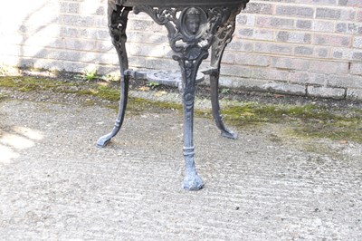 Lot 60 - A cast iron black painted pub table with later...