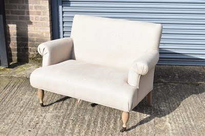 Lot 86 - A modern beige two seater upholstered sofa,...