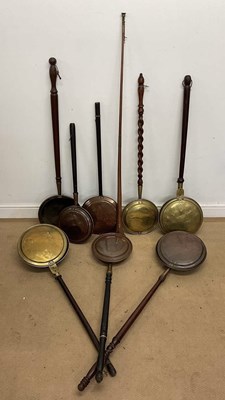 Lot 319 - Eight warming pans, a coaching horn, length...