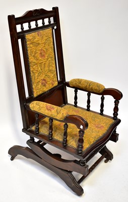 Lot 32 - An American mahogany rocking chair,...