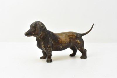 Lot 812 - A bronzed spelter cast figure of a dachshund,...