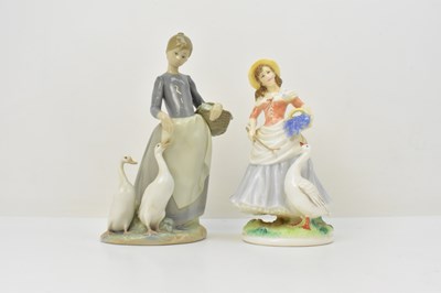 Lot 153 - LLADRÓ; a porcelain figure of a lady feeding...