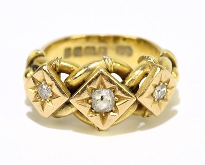 Lot 1023 - An 18ct yellow gold and three stone diamond...