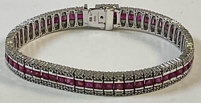 Lot 646 - An 18ct white gold ruby and diamond line...