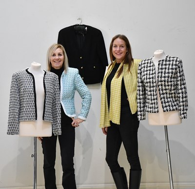 Lot 170 - CHANEL; a black bouclé short jacket with...