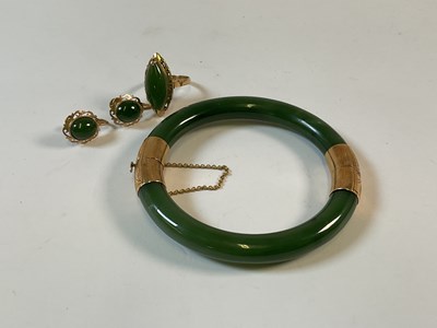 Lot 667 - A suite of Chinese jade and yellow metal...