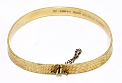 Lot 177 - A 9ct textured yellow gold bangle, misshapen,...